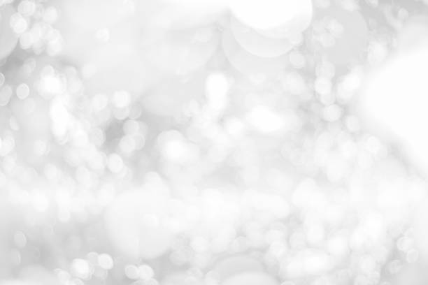 istock Abstract glamorous white and silver bokeh lights glitter sparkle. Defocused background have luxury golden color party invite for birthday, anniversary, holliday, new year xmas or snow christmas blur. 1070497284