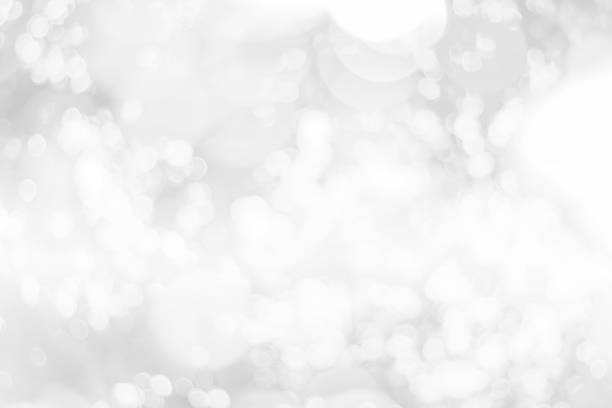 istock Abstract glamorous white and silver bokeh lights glitter sparkle. Defocused background have luxury golden color party invite for birthday, anniversary, holliday, new year xmas or snow christmas blur. 1070497308