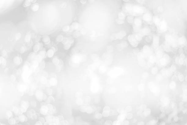 istock Abstract glamorous white and silver bokeh lights glitter sparkle. Defocused background have luxury golden color party invite for birthday, anniversary, holliday, new year xmas or snow christmas blur. 1070497352