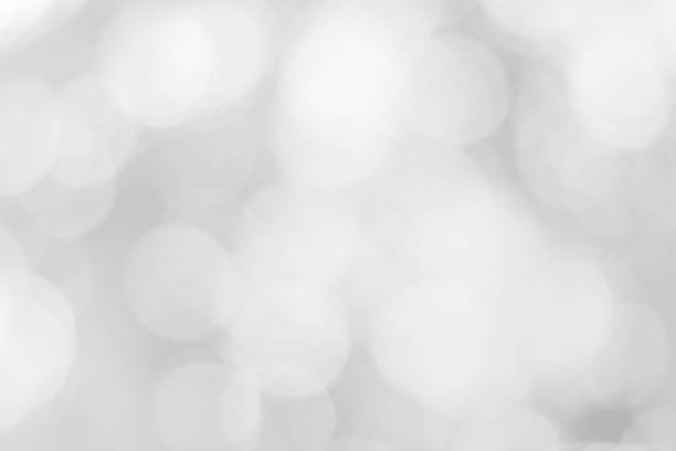 istock Abstract glamorous white and silver bokeh lights glitter sparkle. Defocused background have luxury golden color party invite for birthday, anniversary, holliday, new year xmas or snow christmas blur. 1070497880