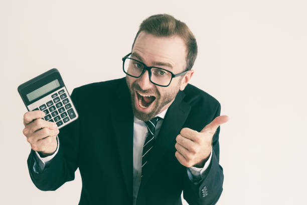 istock Excited business man showing calculator display and thumb up 1070507184