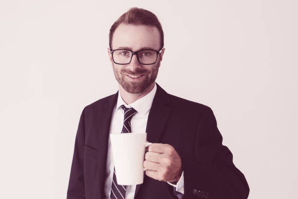 istock Smiling handsome business man holding mug, drinking tea 1070507296