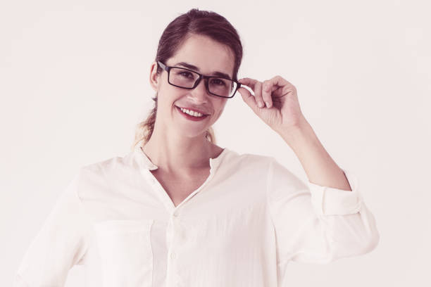 istock Smiling young beautiful woman adjusting glasses 1070507358