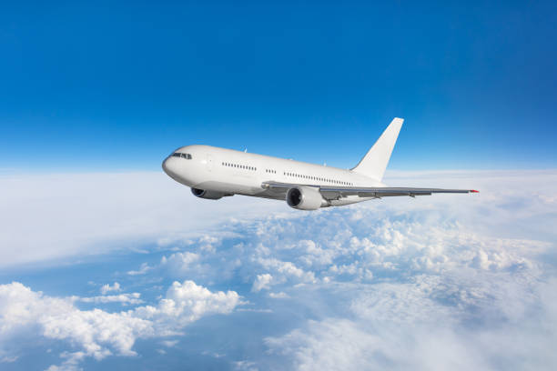 istock Airplane fly in the blue sky in below the clouds. 1070509358