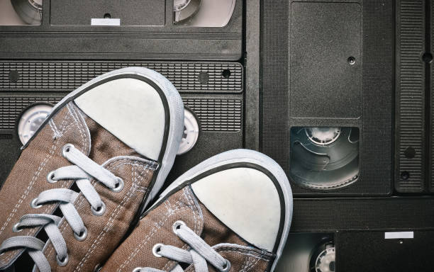 istock retro sneakers on video cassette background, top view 1070509682