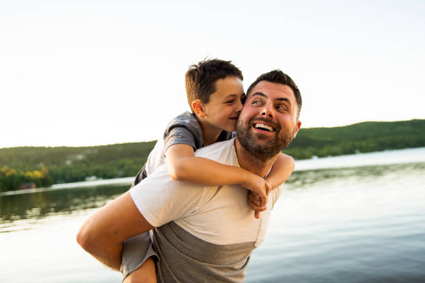 istock father and son on the pier warm summer day having good time 1070510312