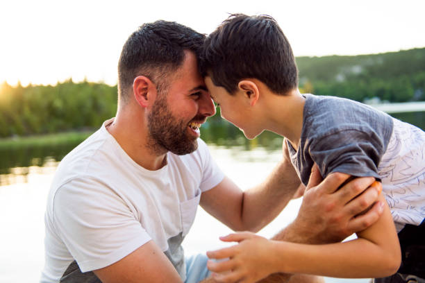 istock father and son on the pier warm summer day having good time 1070510346