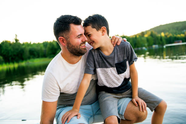 istock father and son on the pier warm summer day having good time 1070510348