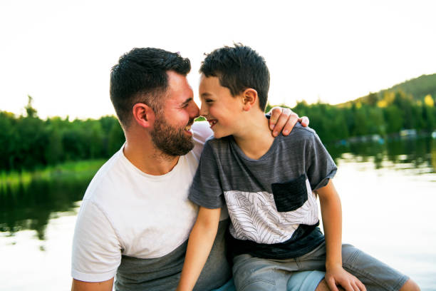 istock father and son on the pier warm summer day having good time 1070510376