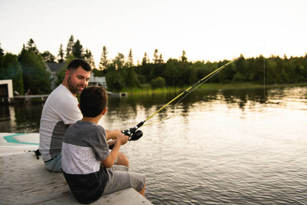 istock Cool Dad and son fishing on lake 1070510792