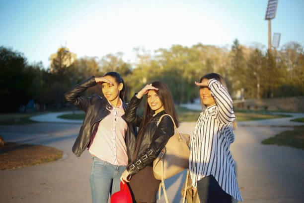 istock Three beautiful young women walking and flirting 1070510806