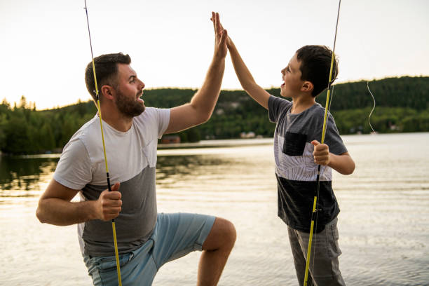 istock Cool Dad and son fishing on lake 1070510824