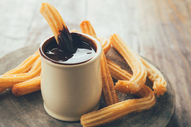 istock Dipping churros on chocolate sauce 1070515604