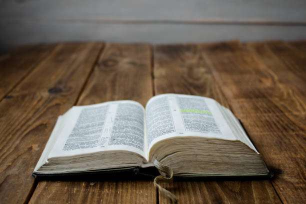 istock a open old bible on wooden background 1070515624