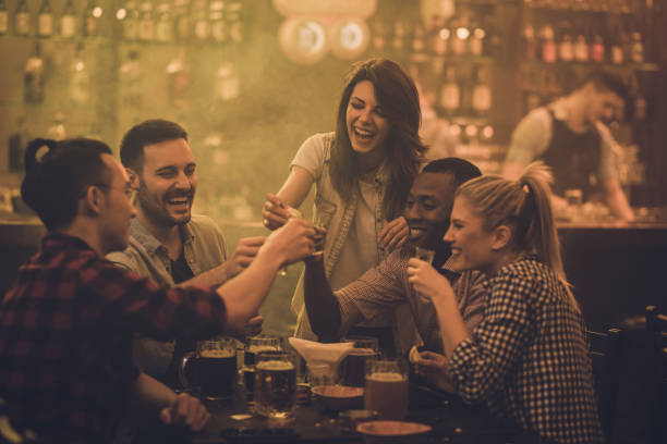 istock Cheerful friends having fun while toasting with shots during their night out in a bar. 1070522150