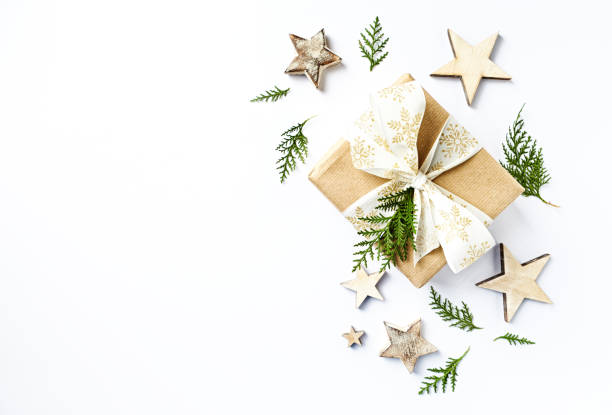istock Christmas present with rustic decorations and evergreen twigs. Flatlay. Copy space. White background 1070529824