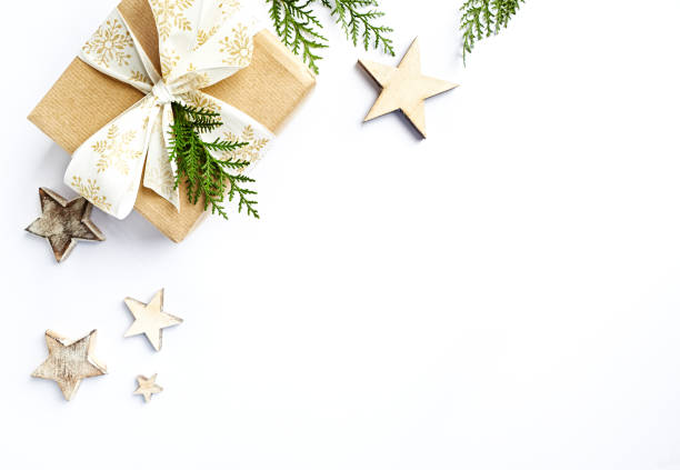istock Christmas present with rustic decorations and evergreen twigs. Flatlay. Copy space. White background 1070529832