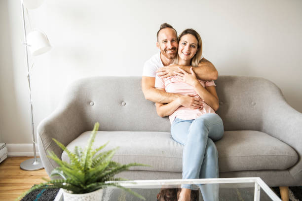 istock Young couple on the sofa relaxing at home 1070533800