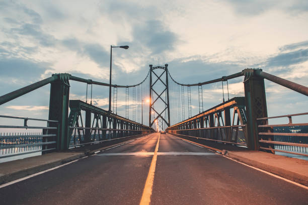 bridge view crossing saint lawrence river from ile d'orleans in quebec - lawrence quebec canada north america imagens e fotografias de stock