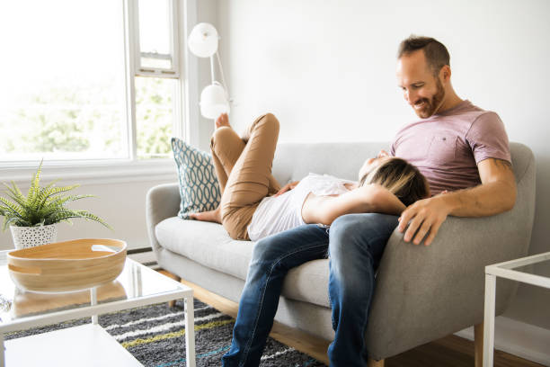 istock Young couple laying on the sofa relaxing at home 1070534186