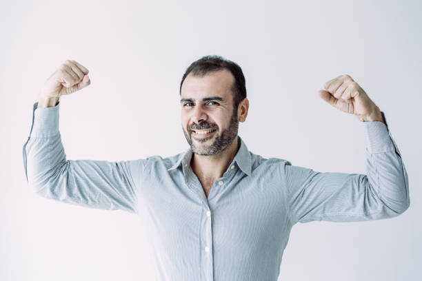 istock Cheerful powerful handsome Latin businessman showing his biceps 1070539176