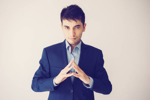 istock Serious business man holding hands together 1070539862