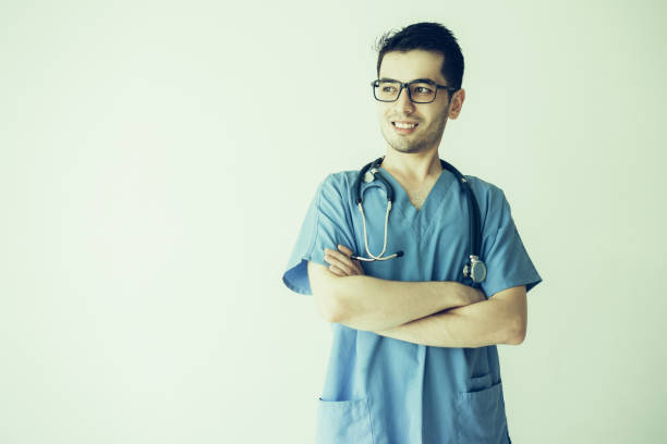istock Smiling handsome young male doctor standing 1070540026