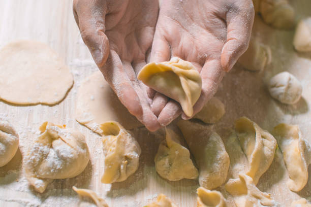 istock Woman hand holding Chinese Dumpling Jiaozi 1070543736