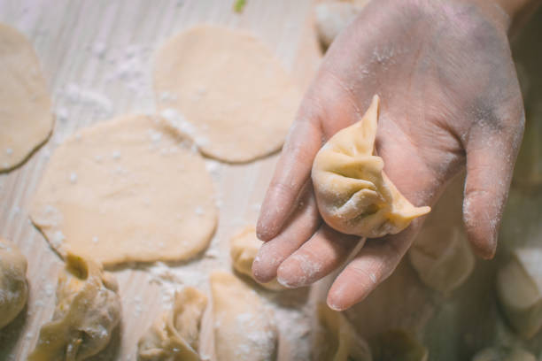 istock Woman hand holding Chinese Dumpling Jiaozi 1070543810