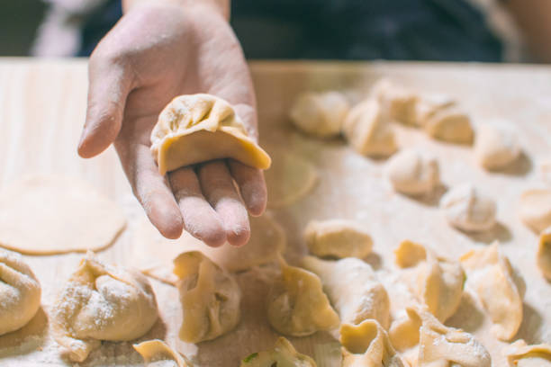 istock Woman hand holding Chinese Dumpling Jiaozi 1070543992