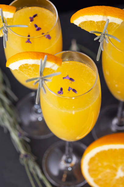 trzy koktajle mimozy - lavender orange fruit table zdjęcia i obrazy z banku zdjęć
