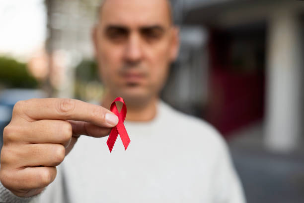 istock man with red ribbon for the fight against AIDS 1070552500