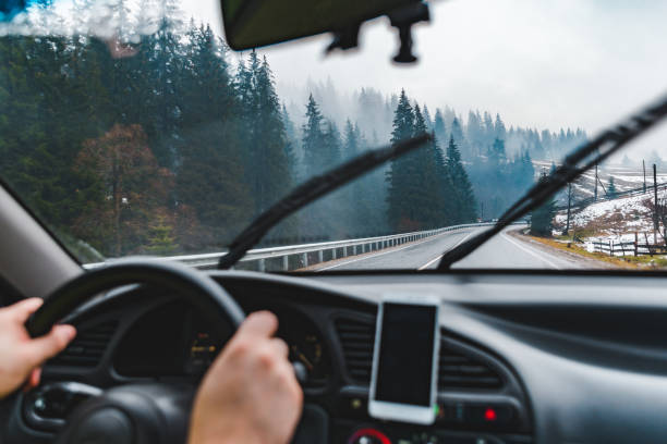istock man driving car by snowed mountains road 1070552866