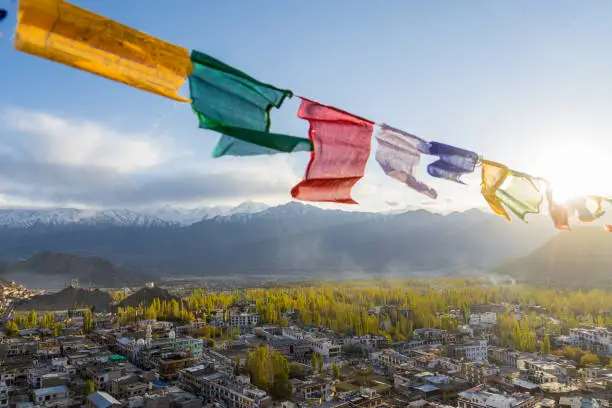 The colorful prayer flags with landscape view of the Leh city in autumn and mountain in background