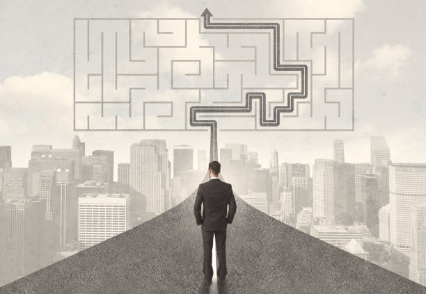 istock Businessman looking at road with maze and solution 1070563484