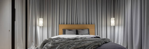 bedroom with decorative gray curtains - door symmetry wood hotel imagens e fotografias de stock
