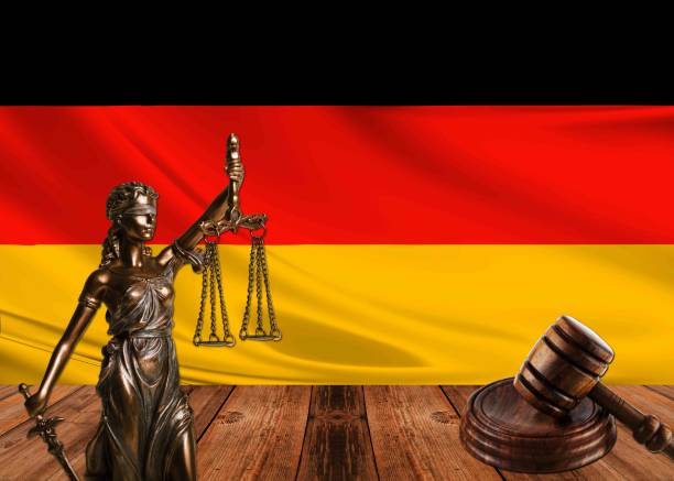 istock statue of justice with hammer and germany flag 1070579518