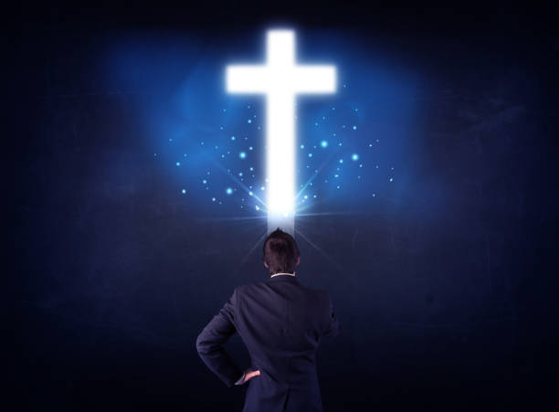 istock Businessman in front of a glowing cross 1070579868