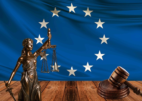 statue of justice with hammer and european union flag