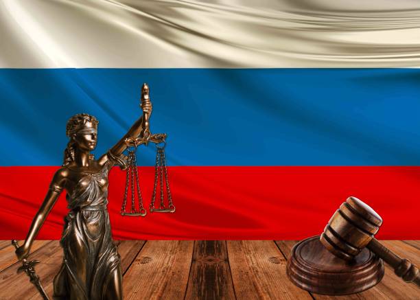 istock statue of justice with hammer and russia flag 1070580982