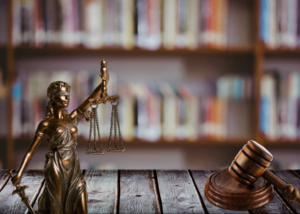 istock hammer with statue and justice in the library 1070582798