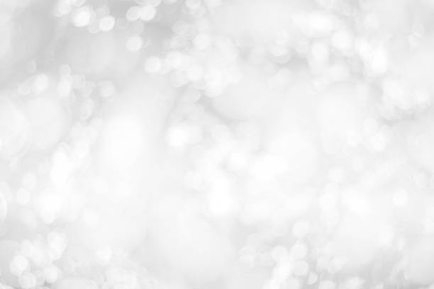 istock Abstract glamorous white and silver bokeh lights glitter sparkle. Defocused background have luxury golden color party invite for birthday, anniversary, holliday, new year xmas or snow christmas blur. 1070589248