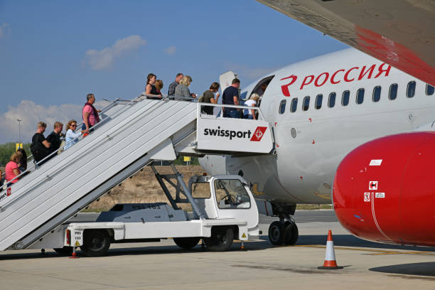 larnaca, cyprus - november 6. 2018. passengers enter the plane . rossiya airline - entering airplane imagens e fotografias de stock