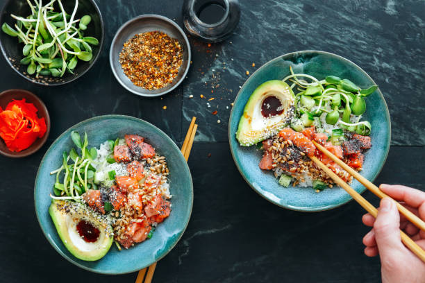 Man eating poke bowls with ponzu dressing