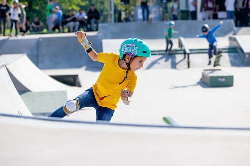 Young Girl Skateboarding in Skatepark.