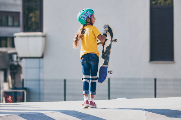 istock Young Skateboarding Girl With Her Skateboard 1070595706
