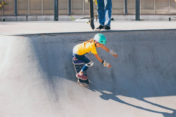 istock Young Skateboarding Girl Gaining Speed on Quarter Pipe 1070595726