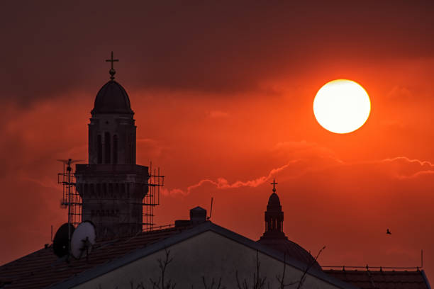 Church towers silhouette in stunning sunset