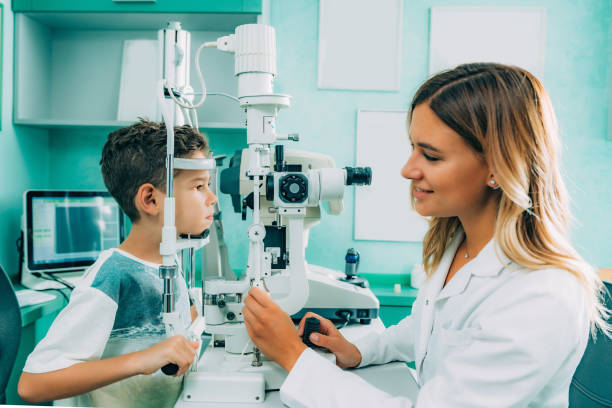 istock Eye Exam. Ophthalmology, slit lamp exam, school boy having his eye sight checked 1070605008