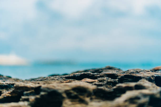 Selective focus od black stone texture for put product to show with beach in background.